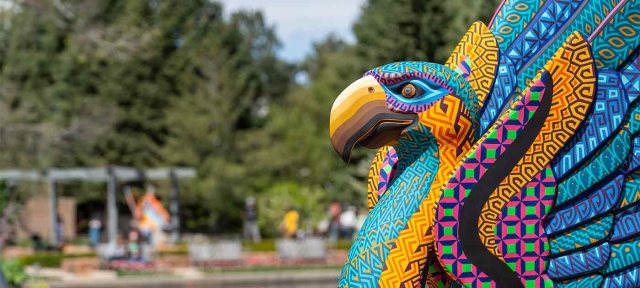Brightly colored and richly patterned sculpture of an imaginary hybrid animal