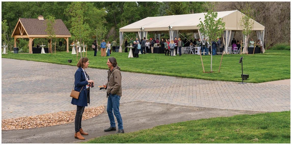 A group of people are standing outside under a tent. AI generated content
