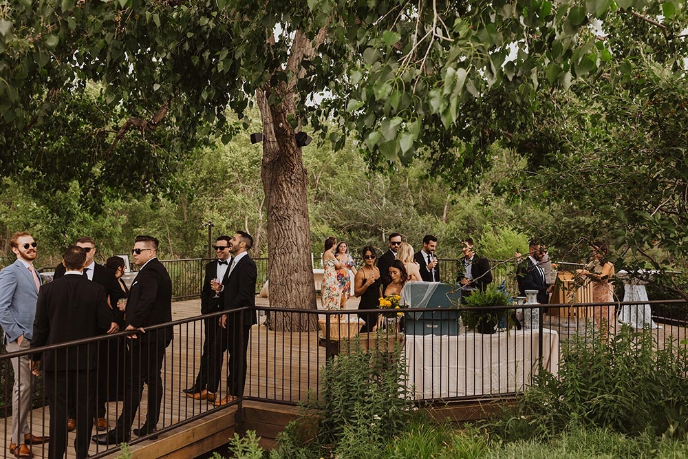 People outside on a deck during a wedding reception