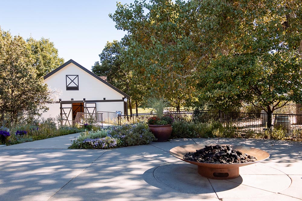 Firepit in the foreground with stables in the background