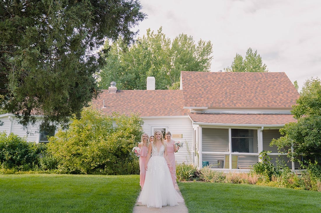 Bride and bridesmaids leaving a building, getting ready  to go the the wedding site