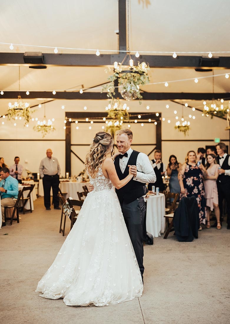 Bride and groom dancing inside under the lights