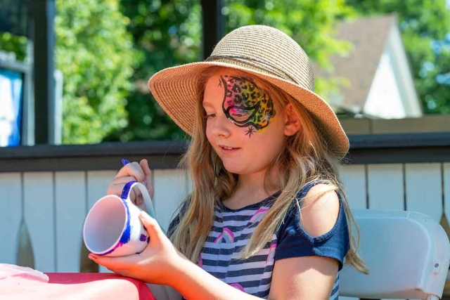 Child painting a cup at Lavender Festival