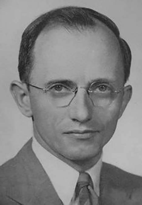 Black and white headshot man with glasses