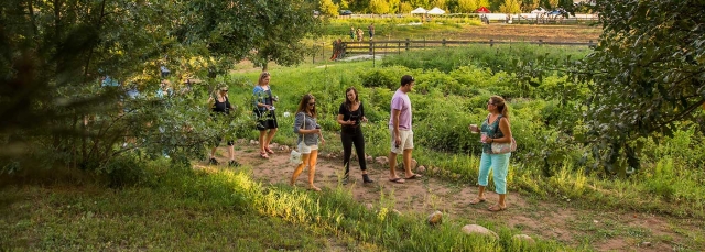 A group of people taking a tour outside at Chatfield Farms
