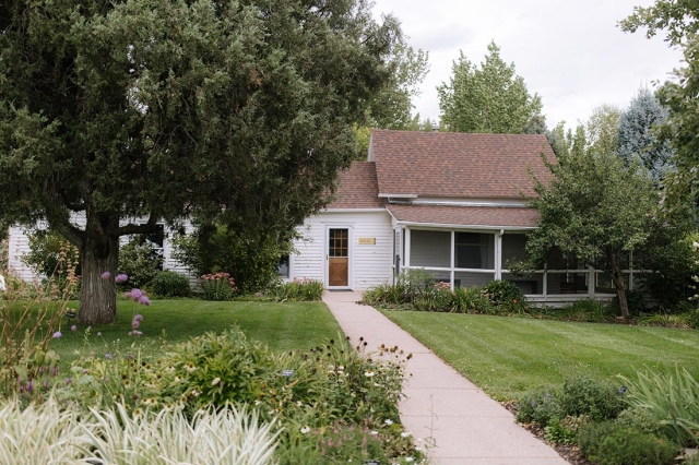 Building in the background with grass and trees in the foreground