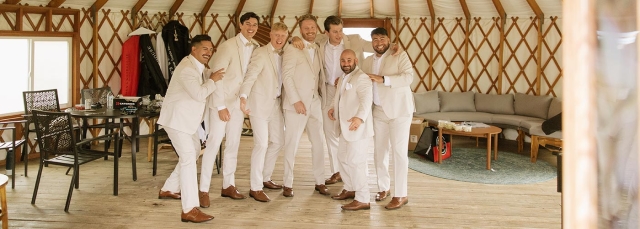 Men getting ready in a yurt for a wedding