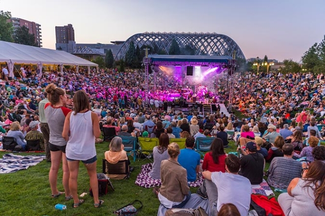 A crowd gathered to watch a stage at summer concert series