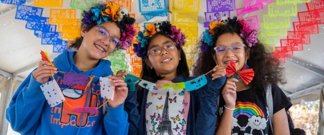 Three young people at Dia de los Muertos Festival in 2021