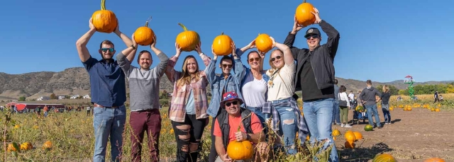 People holding pumpkins at Pumpkin Festival